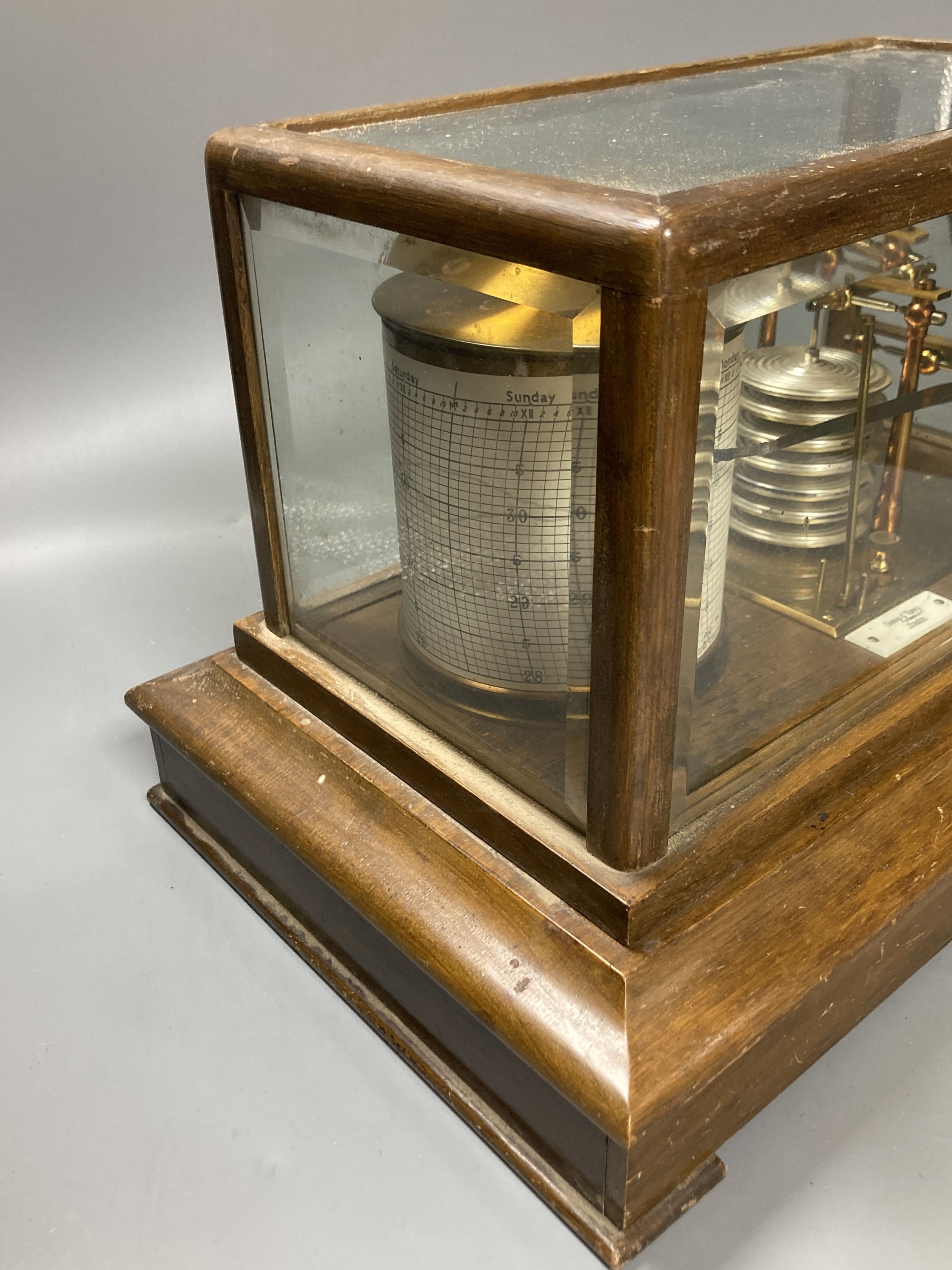 An Edwardian oak barograph retailed by Army & Navy stores ltd. with ink and spare sheets.